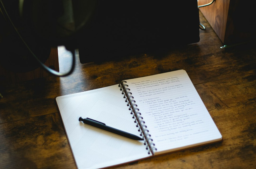 writer at desk with notebook